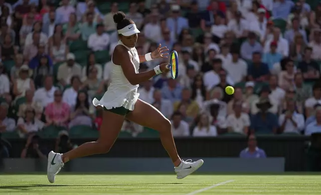Naomi Osaka of Japan returns the ball to Aryna Sabalenka of Belarus in their fourth round women's singles match at the Wimbledon Tennis Championships in London, Sunday, July 5, 2026. (AP Photo/Brian Inganga)