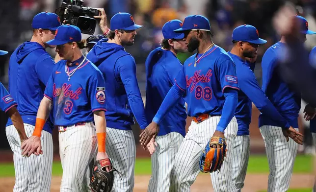 New York Mets' Luis Robert Jr. (88) celebrates with teammates after a baseball game Miami Marlins Thursday, July 30, 2026, in New York. (AP Photo/Frank Franklin II)