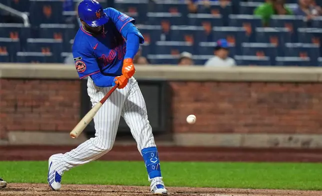 New York Mets' Luis Robert Jr. hits a two-run single during the eighth inning of a baseball game against the Miami Marlins Thursday, July 30, 2026, in New York. (AP Photo/Frank Franklin II)