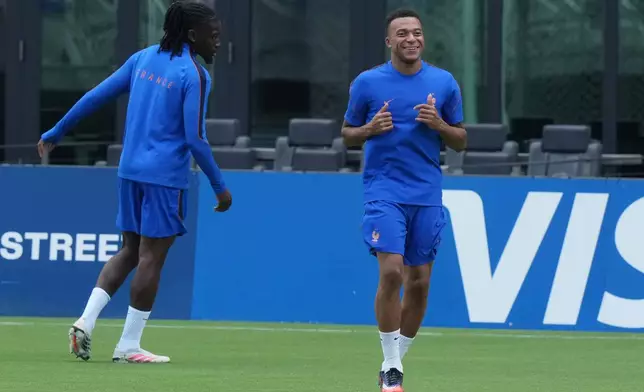 France's Kylian Mbappe, right, participates in a training session with the team ahead of their Bronze medal World Cup soccer match against England Friday, July 17, 2026, in Fort Lauderdale, Fla. (AP Photo/Marta Lavandier)