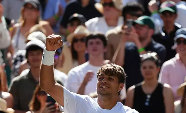 Flavio Cobolli of Italy celebrates winning against Alex de Minaur of Australia in their fourth round men's singles match at the Wimbledon Tennis Championships in London, Monday, July 6, 2026. (AP Photo/Maja Smiejkowska)