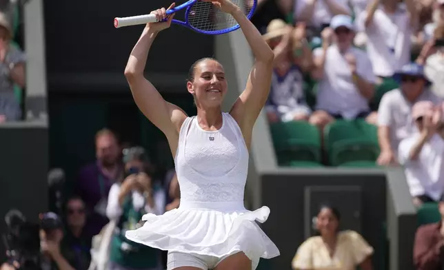 Marta Kostyuk of Ukraine dances to celebrate her victory against Ashlyn Krueger of the United States in their fourth round women's singles match at the Wimbledon Tennis Championships in London, Monday, July 6, 2026. (AP Photo/Brian Inganga)