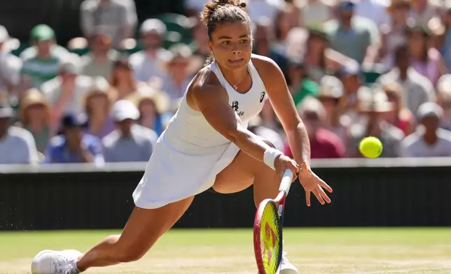 Jasmine Paolini of Italy plays a return during the women's singles fourth round match against Alexandra Eala of the Philippines at the Wimbledon Tennis Championships in London, Monday, July 6, 2026.(AP Photo/Kirsty Wigglesworth)