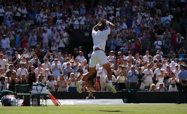 Flavio Cobolli of Italy celebrates winning against Alex de Minaur of Australia in their fourth round men's singles match at the Wimbledon Tennis Championships in London, Monday, July 6, 2026. (AP Photo/Maja Smiejkowska)