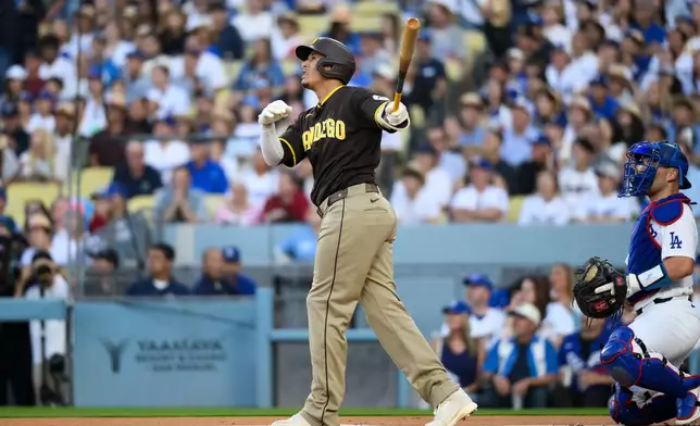 San Diego Padres' Manny Machado hits a two-run home run during the first inning of a baseball game against the Los Angeles Dodgers in Los Angeles, Thursday, July 2, 2026. (AP Photo/Kyusung Gong)