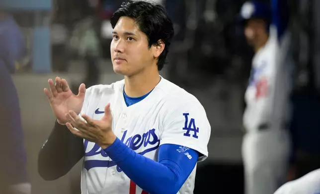 Los Angeles Dodgers' Shohei Ohtani applauds during the fourth inning of a baseball game against the San Diego Padres in Los Angeles, Thursday, July 2, 2026. (AP Photo/Kyusung Gong)