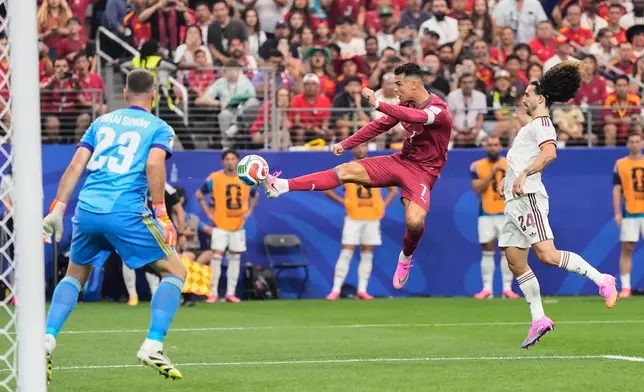 Portugal's Cristiano Ronaldo (7) shoots against Spain goalkeeper Unai Simon (23) during the World Cup round of 16 soccer match in Arlington, Texas, near Dallas, Monday, July 6, 2026. (AP Photo/Ashley Landis)