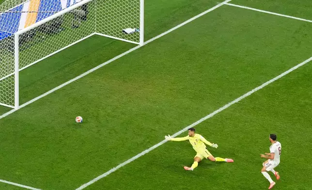 Spain's Mikel Merino (6) scores the opening goal as Portugal goalkeeper Diogo Costa (1) tries to stop him during the World Cup round of 16 soccer match between Portugal and Spain in Arlington, Texas, near Dallas, Monday, July 6, 2026. (AP Photo/Jessica Tobias)