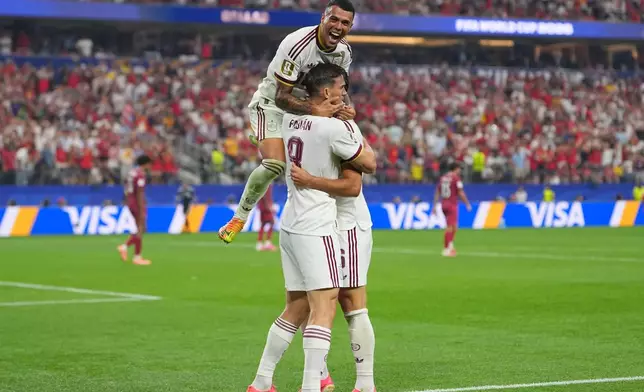 Spain's Pedro Porro, top, congrats Spain's Mikel Merino, right, after scored during the World Cup round of 16 soccer match between Portugal and Spain in Arlington, Texas, near Dallas, Monday, July 6, 2026. (AP Photo/Julio Cortez)