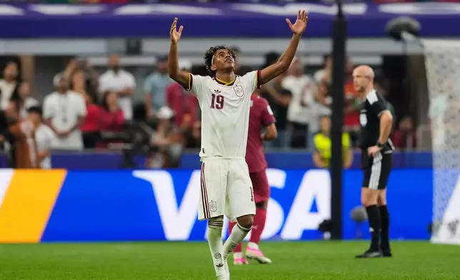 Spain's Lamine Yamal (19) celebrates after Spain's Mikel Merino (6) scored their first goal during the World Cup round of 16 soccer match between Portugal and Spain in Arlington, Texas, near Dallas, Monday, July 6, 2026. (AP Photo/Tony Gutierrez)