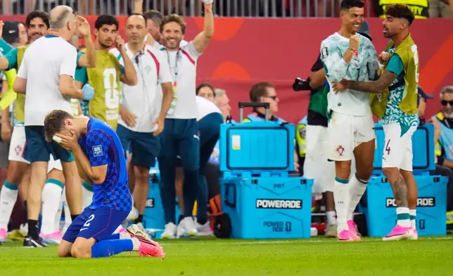 Croatia's Josip Stanisic (2) reacts as a goal is disallowed as Portugal's Cristiano Ronaldo, second right, celebrates during the second half of a World Cup round of 32 soccer match, in Toronto on Thursday, July 2, 2026. (Chris Young/The Canadian Press via AP)