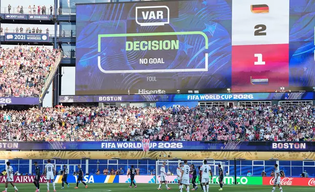 The screen shows that a goal by Germany's Jonathan Tah (4) was disqualified after a VAR check during the World Cup round of 32 soccer match between Germany and Paraguay in Foxborough, Mass., near Boston, Monday, June 29, 2026. (AP Photo/Martin Meissner)