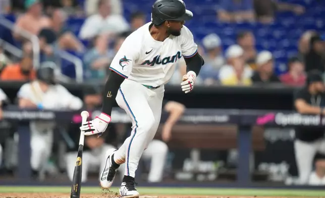 Miami Marlins' Otto Lopez runs after hitting a triple to break a franchise record with the most hits before the All Star break during the fourth inning of a baseball game against the Seattle Mariners, Thursday, July 9, 2026, in Miami. (AP Photo/Lynne Sladky)