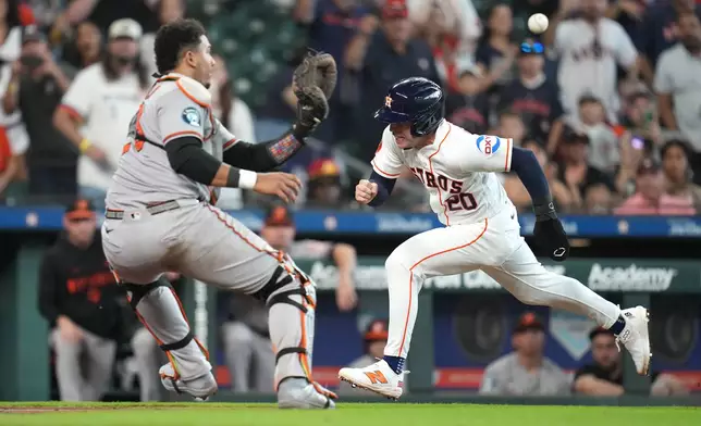 Houston Astros' Nick Allen is tagged out at the plate by Baltimore Orioles catcher Samuel Basallo as Jose Altuve flied into a double play during the tenth inning of a baseball game, Saturday, July 18, 2026, in Houston. (AP Photo/Karen Warren)