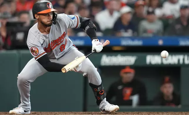 Baltimore Orioles' Jeremiah Jackson hits a sacrifice bunt to score a run during the tenth inning of a baseball game against the Houston Astros, Saturday, July 18, 2026, in Houston. (AP Photo/Karen Warren)