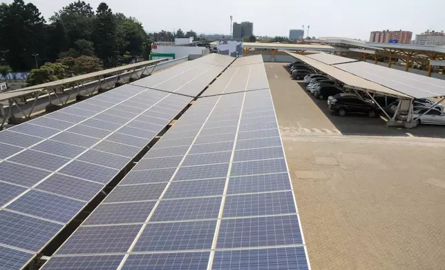 Solar panels cover the parking lot of Garden City Mall in Nairobi, Kenya, Tuesday, July 16, 2026. (AP Photo/Andrew Kasuku)