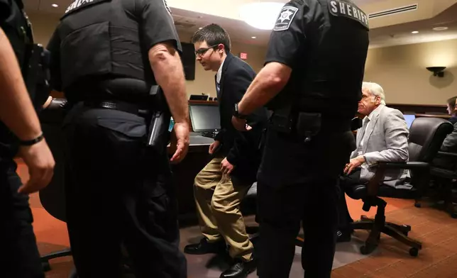 Colt Gray, the 16-year-old convicted in the Apalachee High School shooting, stands to be handcuffed following his sentencing at Barrow County Superior Court in Winder, Ga., on Tuesday, July 28, 2026. (Arvin Temkar/Atlanta Journal-Constitution via AP)
