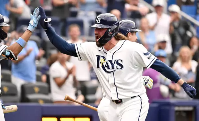 Tampa Bay Rays' Ryan Vilade, front right, celebrates after his three-run home run during the seventh inning of a baseball game against the Seattle Mariners, Saturday, July 11, 2026, in St. Petersburg, Fla. (AP Photo/Jason Behnken)