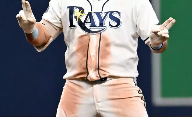 Tampa Bay Rays' Jonathan Aranda celebrates after his double during the seventh inning of a baseball game against the Seattle Mariners, Saturday, July 11, 2026, in St. Petersburg, Fla. (AP Photo/Jason Behnken)