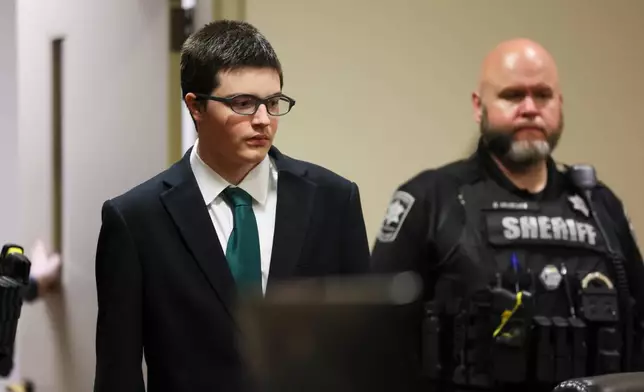 Colt Gray, the 16-year-old Apalachee High School shooting suspect, is led in by deputies for his sentencing at Barrow County Superior Court, Monday, July 27, 2026, in Winder, Ga. (Jason Getz/Atlanta Journal-Constitution via AP, Pool)
