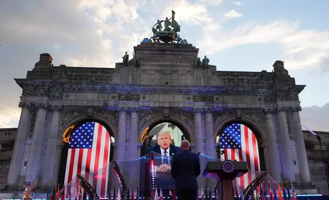 U.S. Ambassador to Belgium Bill White, center, listens to a pre-recorded address by U.S. President Donald Trump during the America 250 event in Brussels, Sunday, June 28, 2026. (AP Photo/Virginia Mayo)