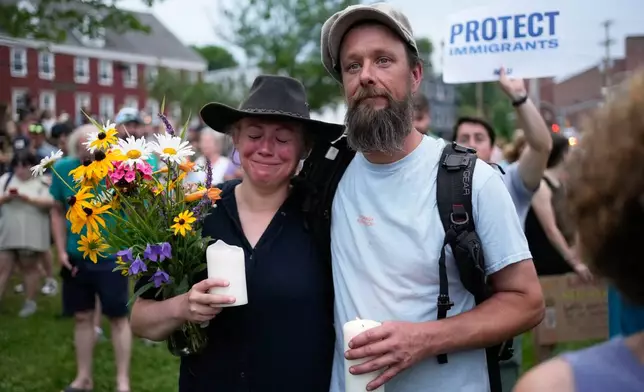 Attendees stand during a vigil after a man was shot and killed by U.S. Immigration and Customs Enforcement on Monday, July 13, 2026, in Biddeford, Maine. (AP Photo/Robert F. Bukaty)