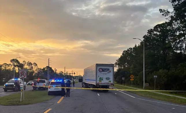 In this photo provided by the St. Johns County Sheriff's Office, the eastbound lanes of SR 16 between Outlet Mall Boulevard and Inman Road in St. Augustine, Fla., are shutdown after a fatal collision. (St. Johns County Sheriff's Office via AP)