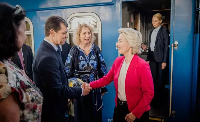 In this photo provided by the Ukrainian Foreign Ministry Press Office, Ukraine's deputy of Foreign Minister Olexander Mischenko, left, welcomes European Commission President Ursula von der Leyen upon her arrival at a railway station in Kyiv, Ukraine, Wednesday, July 15, 2026. (Ukrainian Foreign Ministry Press Office via AP)