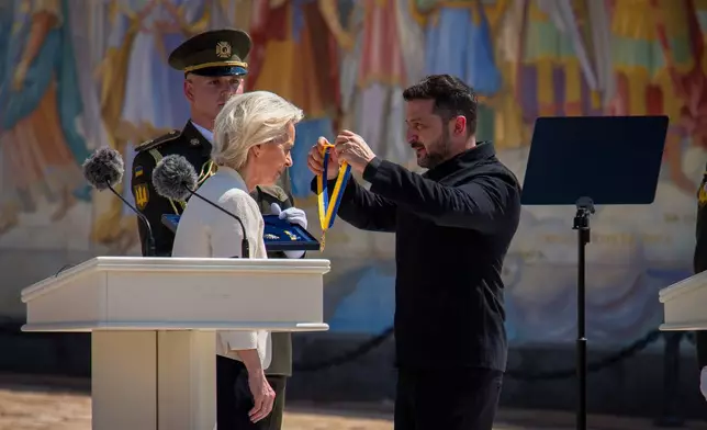 Ukrainian President Volodymyr Zelenskyy, right, awards European Commission President Ursula von der Leyen in Kyiv, Ukraine, Wednesday, July 15, 2026. (AP Photo/Dan Bashakov)