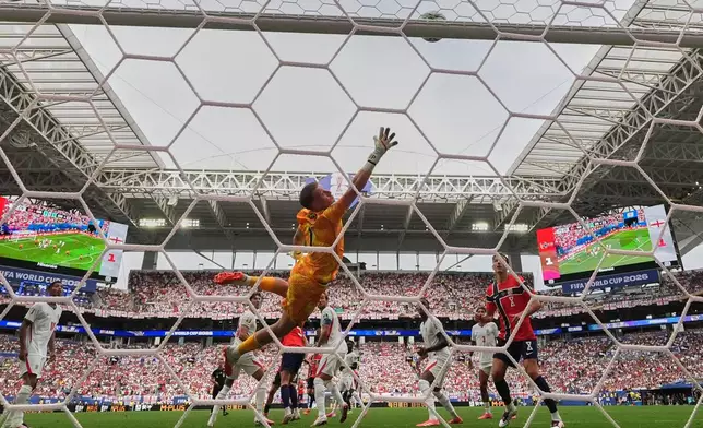 England goalkeeper Jordan Pickford (1) reaches for the ball as it hits the bar during the World Cup quarterfinal soccer match between Norway and England in Miami Gardens, Fla., Saturday, July 11, 2026. (AP Photo/Rebecca Blackwell)