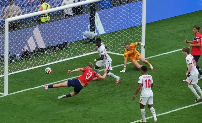 Norway's Torbjoern Heggem (17), right, scores a goal that was later disallowed as England's Marc Guehi (6) and goalkeeper Jordan Pickford (1) defend on the play during the World Cup quarterfinal soccer match between Norway and England in Miami Gardens, Fla., Saturday, July 11, 2026. (AP Photo/Marta Lavandier)