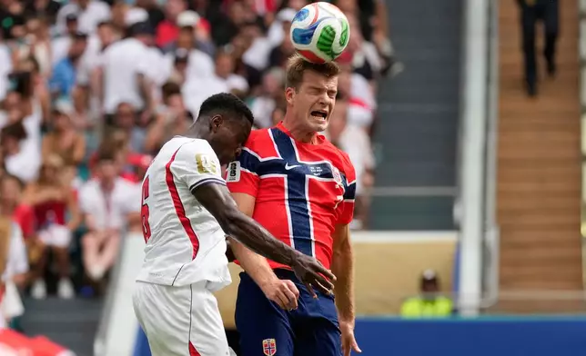 Norway's Alexander Soerloth, right, heads the ball challenged by England's Marc Guehi (6) during the World Cup quarterfinal soccer match between Norway and England in Miami Gardens, Fla., Saturday, July 11, 2026. (AP Photo/Chris Carlson)