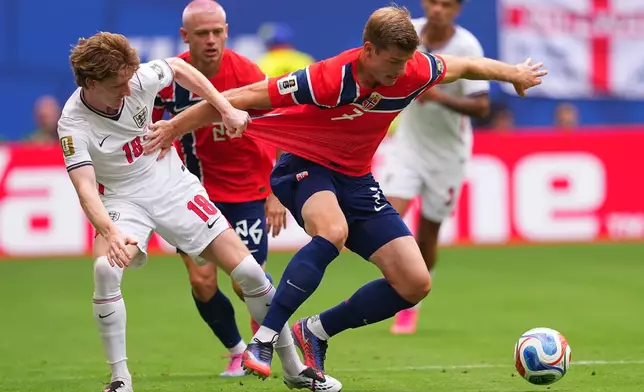 Norway's Alexander Soerloth and England's Anthony Gordon vie for the ball during a World Cup quarterfinal soccer match in Miami Gardens, Fla., Saturday, July 11, 2026. (AP Photo/Julio Cortez)