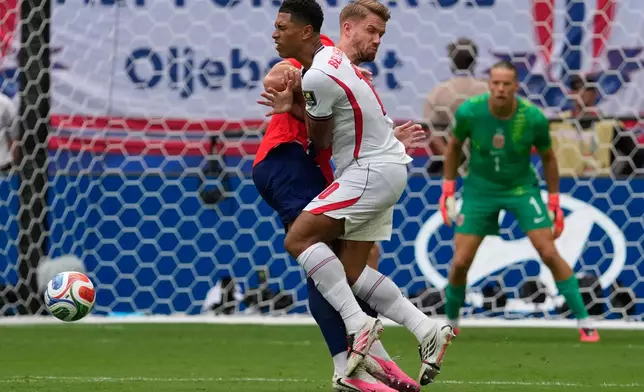 England's Jude Bellingham, front, is fouled by Norway's Kristoffer Ajer during the World Cup quarterfinal soccer match between Norway and England in Miami Gardens, Fla., Saturday, July 11, 2026. (AP Photo/Chris Carlson)