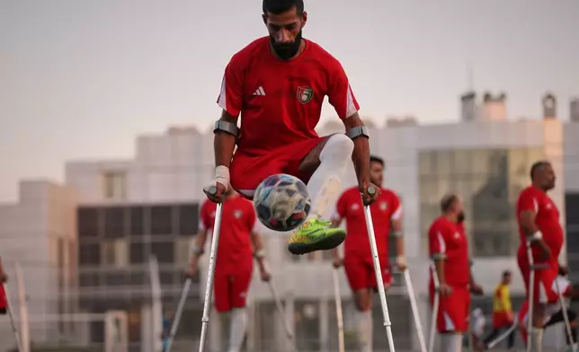 A player juggles the ball during warmups before the final of Syria's first football tournament for people with disabilities at Al-Muhafaza Stadium in Damascus, Syria, Wednesday, July 29, 2026. (AP Photo/Ghaith Alsayed)