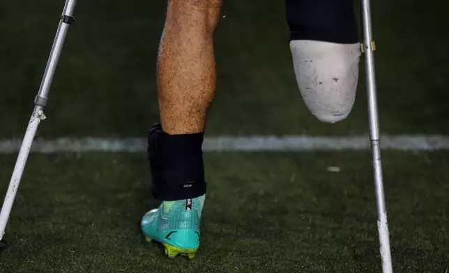 The prosthetic leg and crutches of a player are seen during the final of Syria's first football tournament for people with disabilities at Al-Muhafaza Stadium in Damascus, Syria, Wednesday, July 29, 2026. (AP Photo/Ghaith Alsayed)