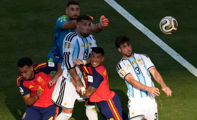 Argentina's Nicolas Tagliafico (3), Argentina's Nicolas Otamendi (19) try to score as Spain's Pedro Porro (12), Spain's Eric Garcia (4) and Spain goalkeeper Unai Simon (23) try to stop them during the World Cup final soccer match between Spain and Argentina in East Rutherford, N.J., near New York, Sunday, July 19, 2026. (AP Photo/Seth Wenig)