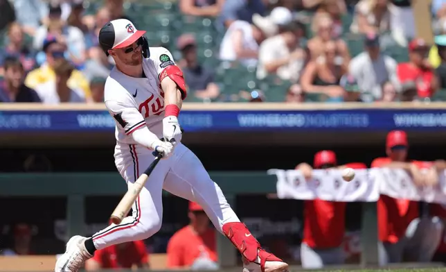 Minnesota Twins' Ryan Jeffers hits a two-run double during the third inning of a baseball game against the Los Angeles Angels, Sunday, July 12, 2026, in Minneapolis. (AP Photo/Bailey Hillesheim)