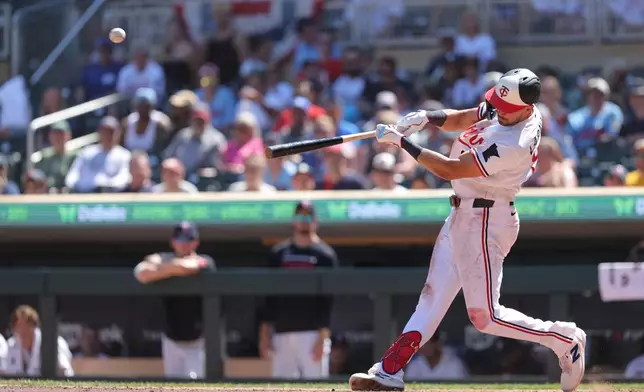 Minnesota Twins' Trevor Larnach hits a solo home run during the eighth inning of a baseball game against the Los Angeles Angels, Sunday, July 12, 2026, in Minneapolis. (AP Photo/Bailey Hillesheim)