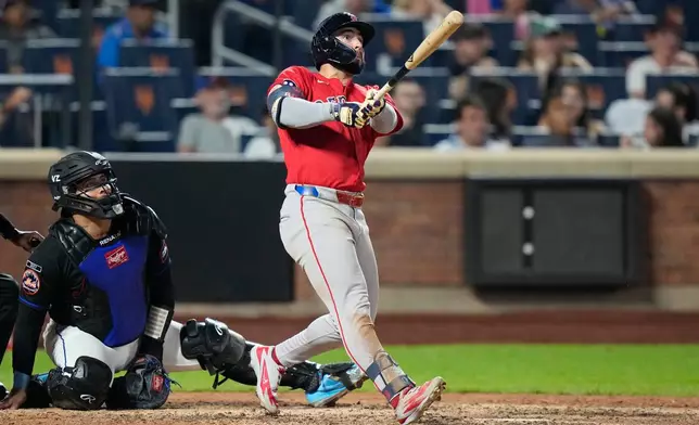 New York Mets catcher Francisco Alvarez, left, watches as Boston Red Sox's Wilyer Abreu follows through on a two-run home run during the ninth inning of a baseball game Friday, July 10, 2026, in New York. (AP Photo/Frank Franklin II)