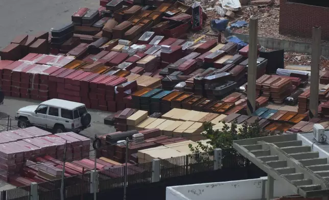 Coffins are stacked at the seaport where forensic workers sort the bodies of earthquake victims in La Guaira, Venezuela, Saturday, July 4, 2026. (AP Photo/Ariana Cubillos)