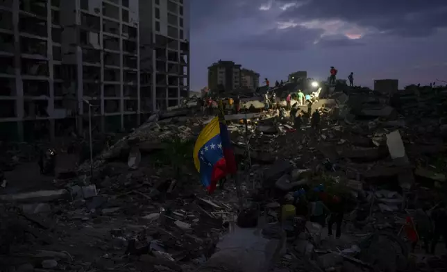 Residents and rescue workers search through the rubble of buildings damaged in the earthquakes that struck La Guaira, Venezuela, Thursday, July 2, 2026. (AP Photo/Matias Delacroix)