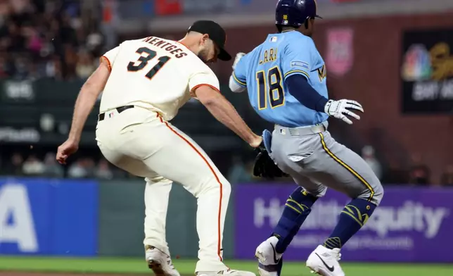 San Francisco Giants pitcher Tyler Mahle (31) tags out Milwaukee Brewers' Luis Lara (18) at first base during the seventh inning of a baseball game in San Francisco, Monday, July 27, 2026. (AP Photo/Jed Jacobsohn)