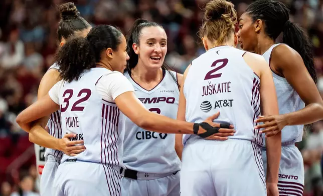 Toronto Tempo's Marina Mabrey, center, celebrates with teammates after drawing a foul against the Dallas Wings during the first half of a WNBA basketball game in Montreal, Friday, July 10, 2026. (Christopher Katsarov/The Canadian Press via AP)