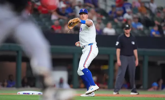 Texas Rangers third baseman Josh Jung throws to first base after fielding a ground out against Chicago White Sox's Chase Meidroth during the second inning of a baseball game, Tuesday, July 21, 2026, in Arlington, Texas. (AP Photo/LM Otero)