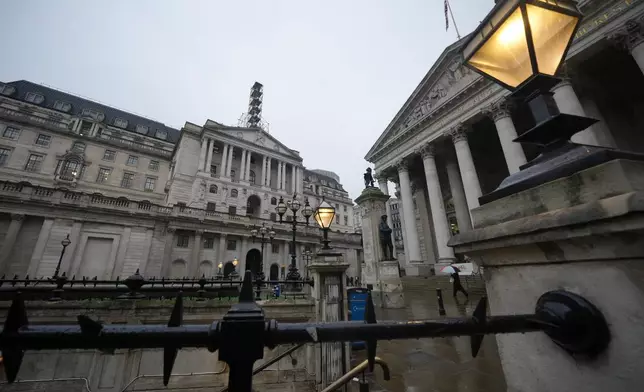 FILE -A man walks in front of the Bank of England, at the financial district in London, Feb. 5, 2026 (AP Photo/Kin Cheung, File)