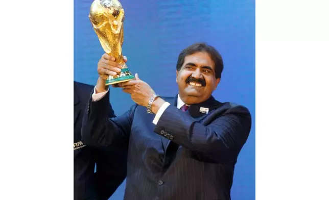 FILE - Sheikh Hamad bin Khalifa Al Thani, Emir of Qatar, holds the World Cup trophy after the announcement of Qatar hosting the 2022 soccer World Cup in Zurich, Switzerland, Dec. 2, 2010. (AP Photo/Anja Niedringhaus, File)