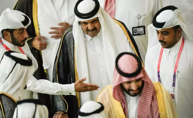 FILE - Former Emir of Qatar Sheikh Hamad bin Khalifa Al Thani, center, arrives before the start of the World Cup group A soccer match between Qatar and Ecuador at the Al Bayt Stadium in Al Khor, Qatar, Nov. 20, 2022. (AP Photo/Hassan Ammar, File)