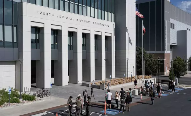 People stand outside the Fourth District Courthouse, Tuesday, July 7, 2026, in Provo, Utah, after a hearing for Tyler Robinson, accused in the fatal shooting of Charlie Kirk. (AP Photo/Spenser Heaps)