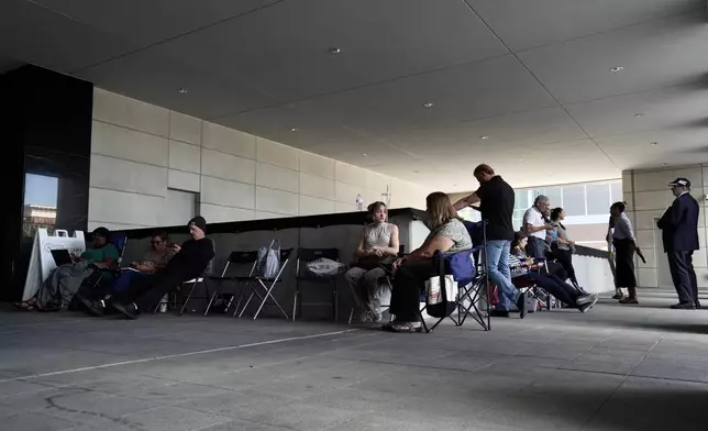 A line forms for people looking to access limited public seating available at a preliminary hearing for Tyler Robinson, the Utah man accused of fatally shooting Charlie Kirk, in Provo, Utah, Wednesday, July 8, 2026. (AP Photo/Ty ONeil)